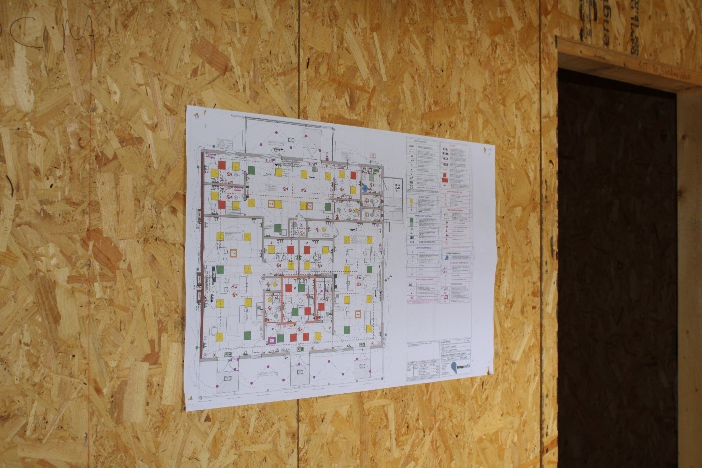 A blue print stuck on a wall at a building site